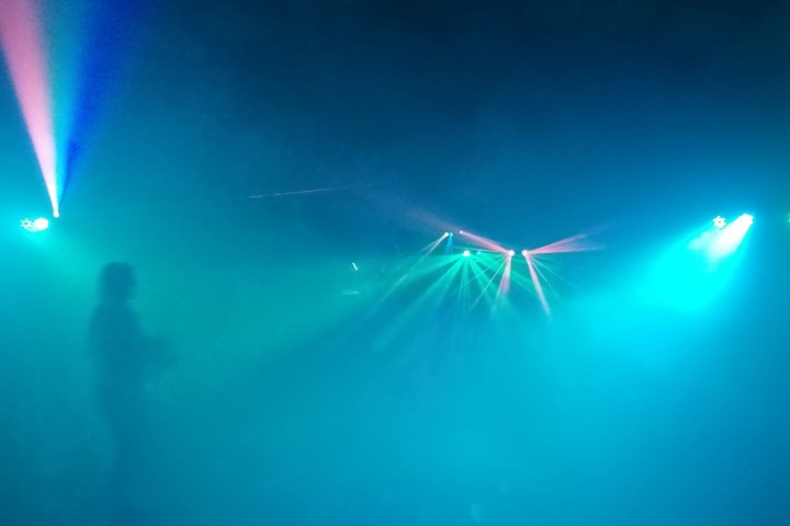 Image of smokey party scene with lights.